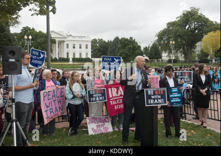 Washington, DC, USA. 12th October, 2017.  Lawrence Korb, former US Assistant Secretary of Defense (1981-1985) speaks to demonstrators in front of the White House to warn of the dangers of President Donald Trump's expected decision to unilaterally decertify the 2015 nuclear accord with Iran.  Numerous groups joined in the protest to denounce Trump's decision to 'bring us closer to war' with Iran, rather than continuing diplomacy with Iran. Bob Korn/Alamy Live News Stock Photo