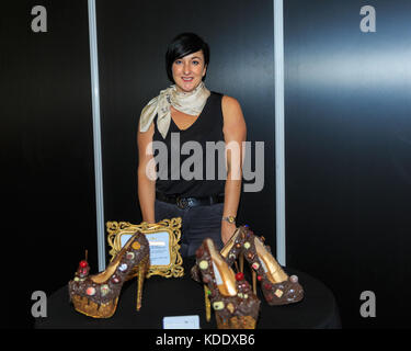 London, UK, 12th Oct 2017. Designer Nina Marie, of Nina Marie Shoes with her Chocolate Shoe creations. Opening night of the Chocolate Show 2017 at Kensington Olympia Exhibition Centre. The show is a celebration of all things chocolate and runs from 13-15th October, open to trade and public. This year, it features celebrity stages, the Choco L’ART gallery with masterpieces of art made from chocolate, a nearly 2 metre high chocolate wall and many other exciting exhibits. Credit: Imageplotter News and Sports/Alamy Live News Stock Photo
