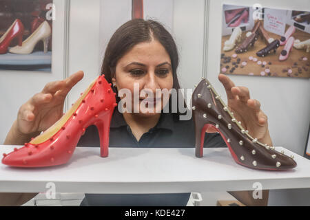 London, UK. 13th Oct, 2017. Chocolatier Azra Sadiq with a display of Louis Vuitton chocolate shoes at the Chocolate Show which opens at London Olympia showcasing and celebrating a wide range of domestic cocoa and chocolate products and confectionary from British and International chocolate makers Credit: amer ghazzal/Alamy Live News Stock Photo