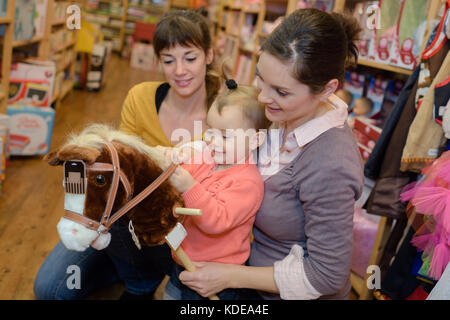 charming family spends time in toy shop Stock Photo