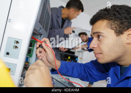 technician fixing cables Stock Photo