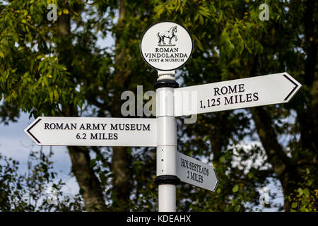 Sign post with directions to the Roman Army Museum, Rome, and Housesteads at entrance Chesterholm, Vindolanda, Bardon Mill, Hexham, Northumberland. Stock Photo