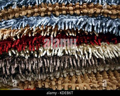 Photo of a stack of assorted colored floor mats Stock Photo