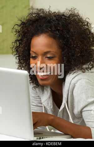 Beautiful mature woman smiling and shopping online. Stock Photo