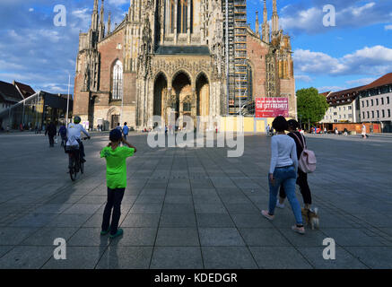 Ulm, Germany - 28th July 2017: Boy taking picture of Ulm Minster (Ulmer Münster)