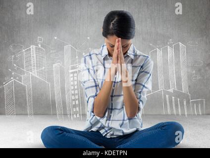 Digital composite of Woman praying meditating in front of city drawings Stock Photo