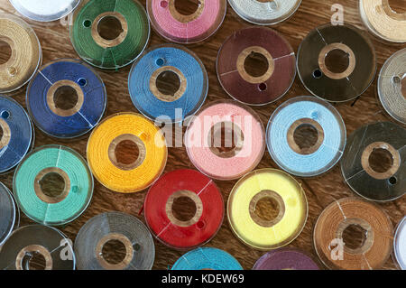 Close-up on colored sewing threads on spools. Top view. Stock Photo