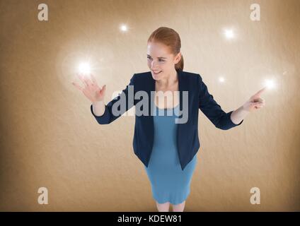 Digital composite of Businesswoman touching sparkling lights Stock Photo