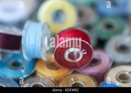 Close-up on colored sewing threads on spools Stock Photo