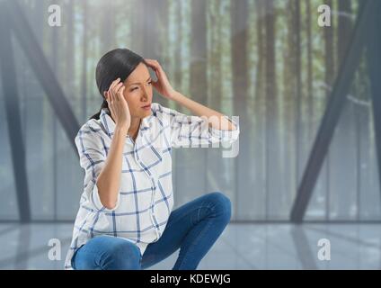 Digital composite of Woman holding head by forest windows Stock Photo