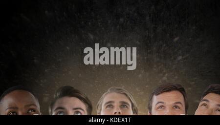 Digital composite of heads looking up at question mark Stock Photo