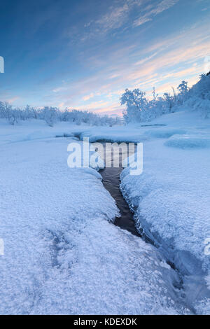 Sunrise on the frozen river, Abisko, Kiruna Municipality, Norrbotten County, Lapland, Sweden Stock Photo
