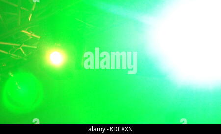 strobe lights emitting different color beams hanging under the ceiling. Stock Photo