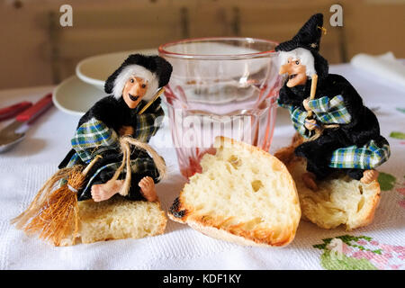 Epiphany and Halloween homemade happy dolls staying on a wood table ready for lunch. Florence, Italy Stock Photo