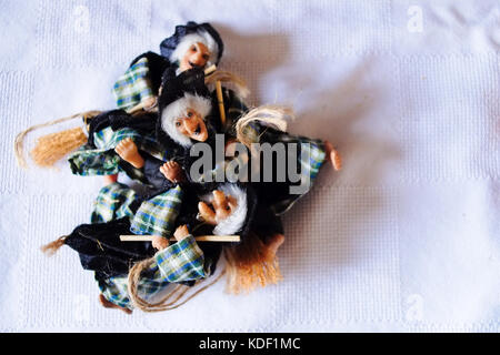 Epiphany and Halloween homemade happy dolls staying on a wood table ready for lunch. Florence, Italy Stock Photo