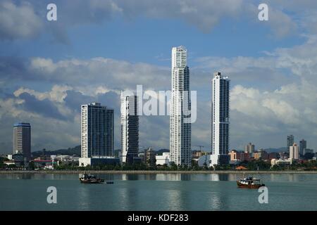 Day view of Panama City Over Panama Bay with skyline and a fishing boat on the foreground Stock Photo