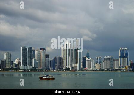 View of Panama City Over Panama Bay with skyline and a fishing boat on the foreground Stock Photo