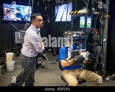 NASA Extravehicular Activity Trainer Steve Vilano coaches NASA astronaut Nick Hague as he uses a virtual reality simulator for a a spacewalk emergency training scenario with the Simplified Aid for EVA Rescue (SAFER) pack at the Johnson Space Flight Center virtual reality lab April 26, 2017 in Houston, Texas.    (photo by J.M. Eddins Jr. via Planetpix) Stock Photo