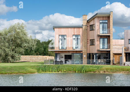 An impressive modern holiday home, sitting beside Minety Lake at the Lower Mill Estate in the Gloucestershire Cotswolds, UK Stock Photo