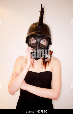 Girl in an alternative fashion picture wearing a gas mask Stock Photo