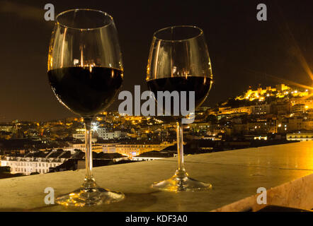 Glasses of Red wine to celebrate with view over Lisbon, Portugal, Europe Stock Photo