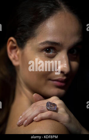 A model wears 'The Raj Pink', the world's largest known 'fancy intense pink diamond' before it is offered at auction, estimated to fetch $20-30 million in Sotheby's Geneva sale of Magnificent and Noble Jewels on 15 November 2017. Stock Photo