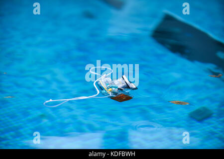 Underwater photo camera housing floating in a swimming pool Stock Photo