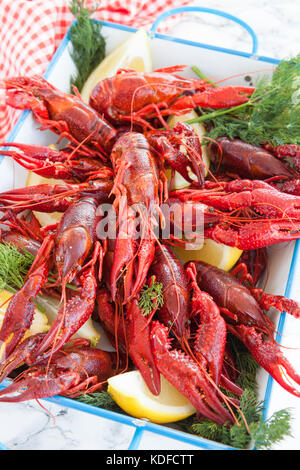 Boiled crawfish with dill and fresh lemon Stock Photo