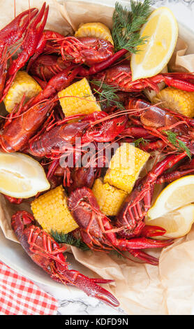 Boiled crawfish with dill and fresh lemon Stock Photo