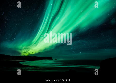 Northern Lights (Aurora Borealis) over Vik from Dyrhólaey, Iceland Stock Photo