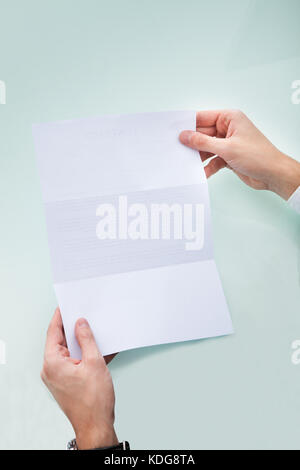 Close-up Of A Person's Hand Holding Blank Paper Stock Photo