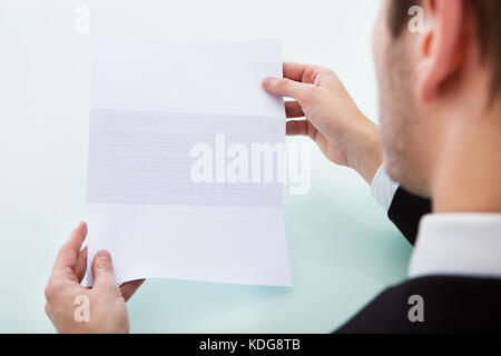 Close-up Of A Person's Hand Holding Blank Paper Stock Photo