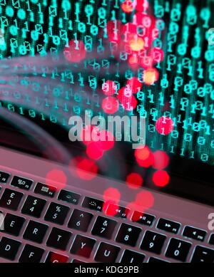 Fibre optic data containing a computer virus hitting a laptop screen. Stock Photo