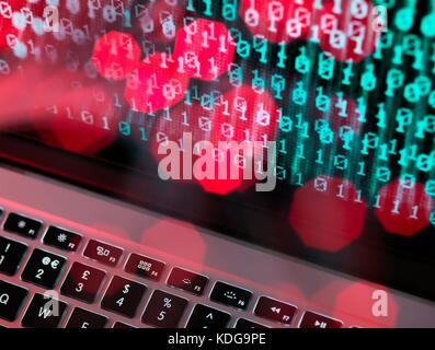 Fibre optic data containing a computer virus hitting a laptop screen. Stock Photo