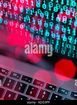 Fibre optic data containing a computer virus hitting a laptop screen. Stock Photo