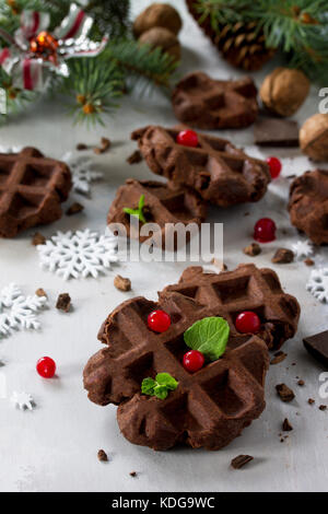 Homemade Belgian chocolate wafers with fresh berries and mint on a gray stone or slate background, Christmas background. Stock Photo