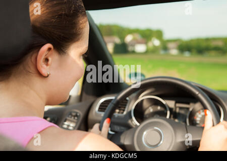 Portrait Of Happy Young Woman Driving The Car Stock Photo