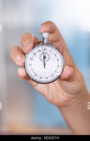 Close-up Of Female Hand Holding Stopwatch In Hand Stock Photo