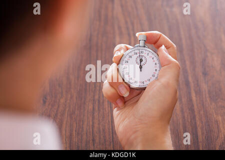 Close-up Of Female Hand Holding Stopwatch In Hand Stock Photo