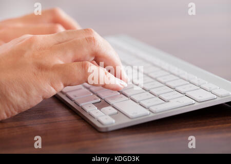 Close-up Of Female Hand Typing On Keyboard Stock Photo