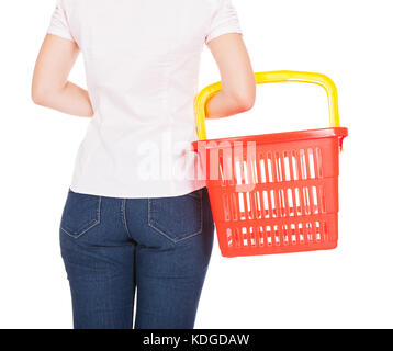 Rear view of a woman holding empty shopping basket Stock Photo