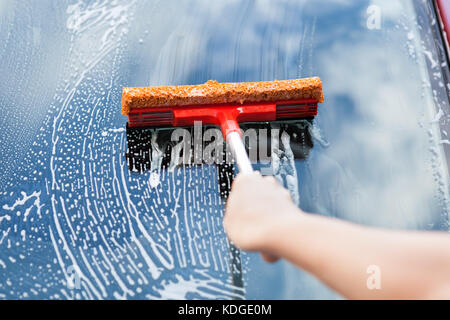 Close-up Of Hand Washing Car Window With Mop Stock Photo