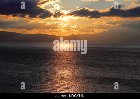 Dramatic sky during sunset over Lake Ohrid near Pogradec in Albania Stock Photo