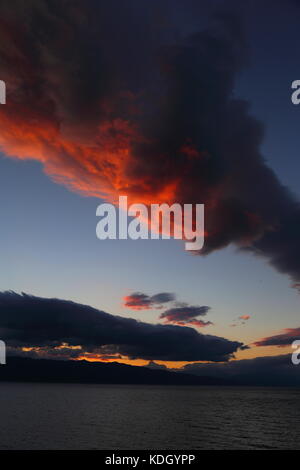 Dramatic sky during sunset over Lake Ohrid near Pogradec in Albania Stock Photo