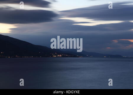 Dramatic sky after sunset over Lake Ohrid near Pogradec in Albania Stock Photo