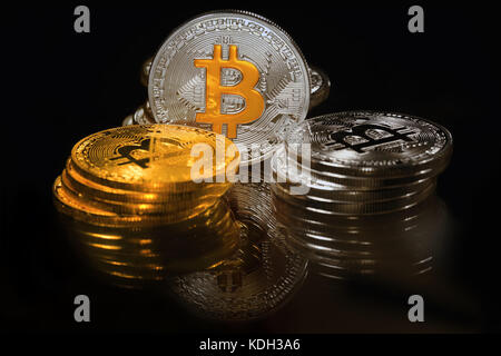 Golden and silver bitcoins on black background. Bitcoin is cryptocurrency Stock Photo