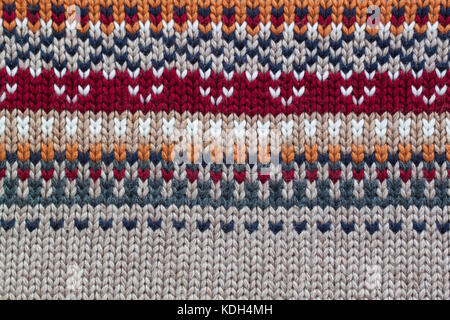Grey, orange, bordo and beige realistic knitting pattern. Jacquard technic Stock Photo