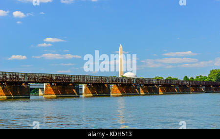 The Long Bridge, part of the 14st Street collection stretches over the Potomac River with the Washington Moument and top of the Jefferson Memorial in  Stock Photo