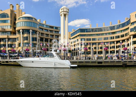 Power boat docked along side the Washington Harbor mixed use development on the banks of the Potomoc  river in Georgetown district of Washington, DC,  Stock Photo