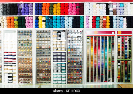view on sewing shop shelves with various knitting yarn, buttons, threads and other supplies Stock Photo